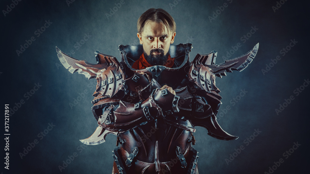 Powerful knight in the armor. Dark background. Powerful knight in the armor. Dark background.