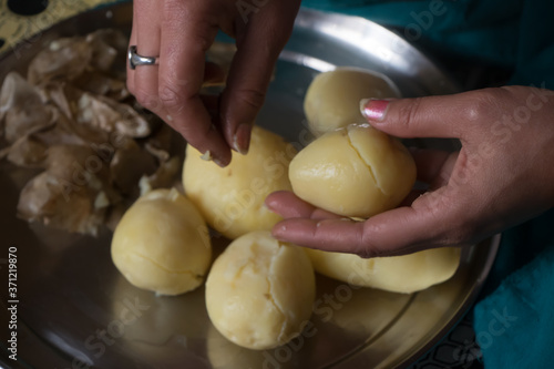 Hands peeling potato outer skin