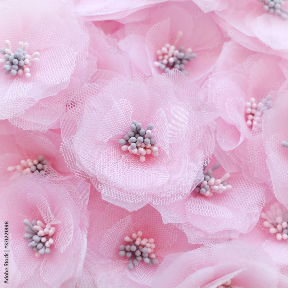 Artificial handmade flowers made out of beautiful organza and tulle fabric texture in soft pink color Artificial handmade flowers made out of beautiful organza and tulle fabric texture in soft pink color
