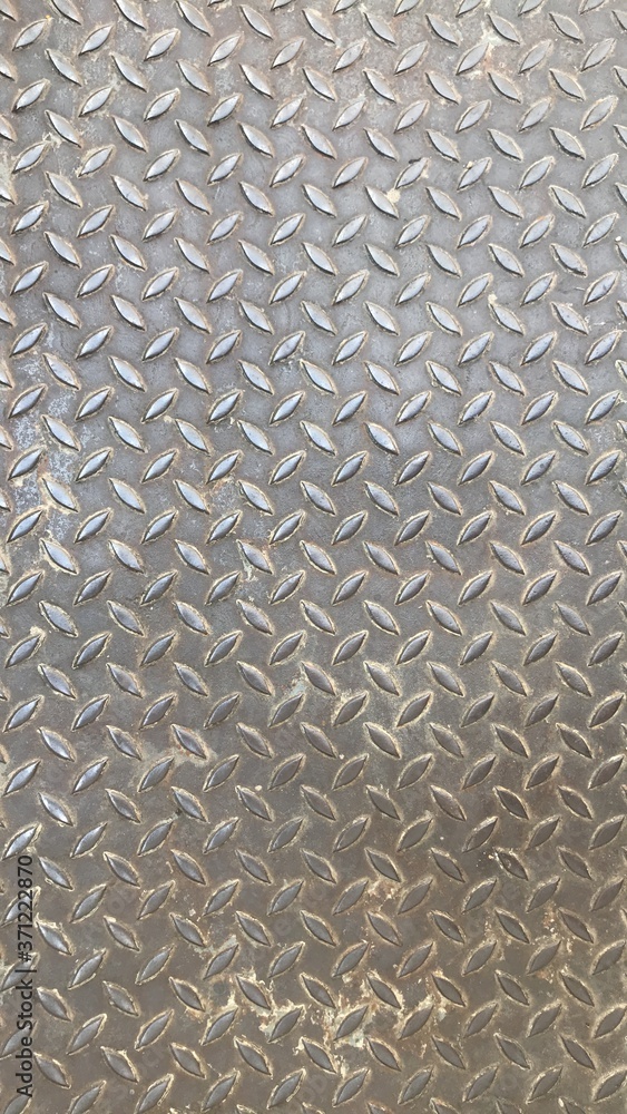 The button patterns background on the metal floor background. The button patterns background on the metal floor background.