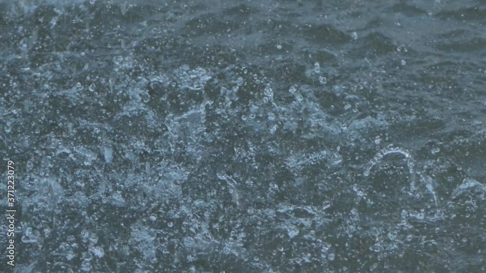 Rain splashes hit the asphalt, heavy rain, close-up Rain splashes hit the asphalt, heavy rain, close-up
