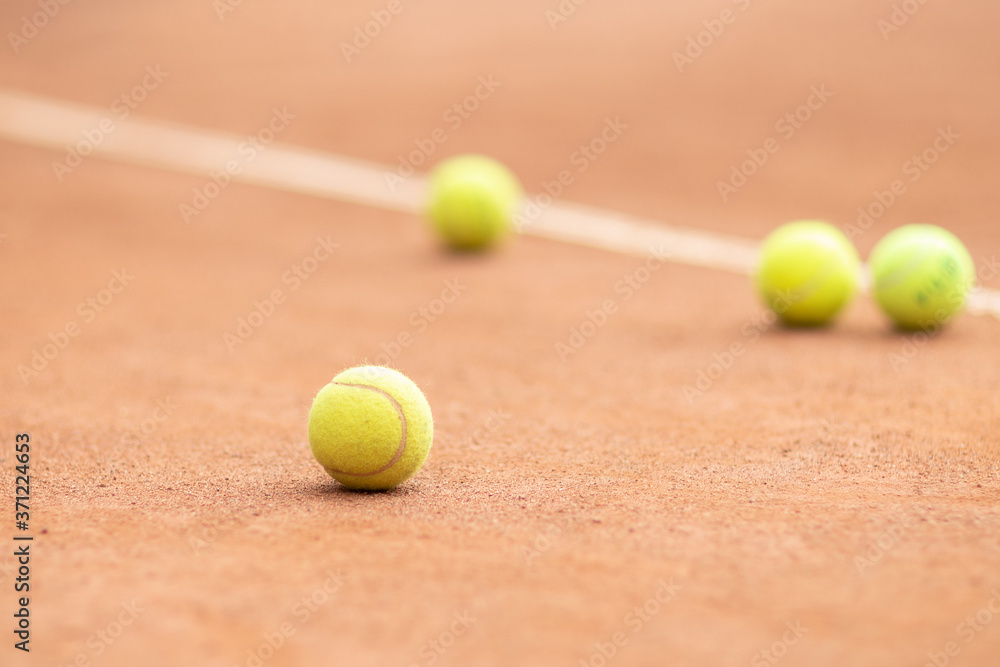 Yellow tennis balls on the court