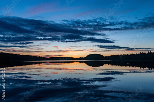 sunset landscape with clouds reflected in the north lake