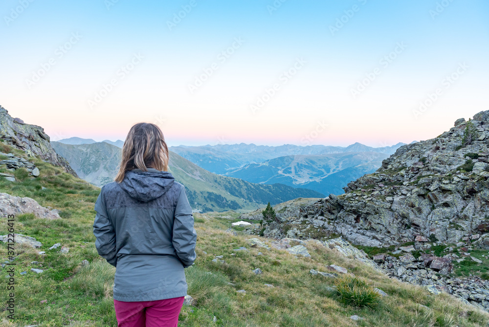 Woman in the Vall de Riu lake from the Estanyo peak in Andorra in summer 2020