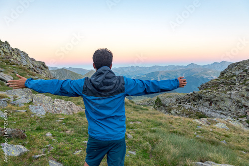 Men in the Vall de Riu lake from the Estanyo peak in Andorra in summer 2020. photo