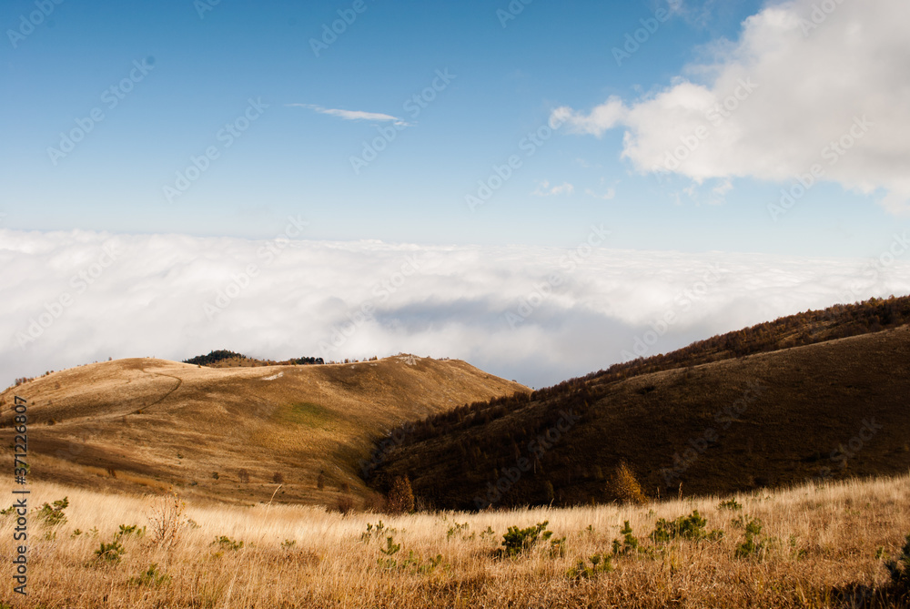 Clouds and alpine meadows in Caucasus mountains in autumn