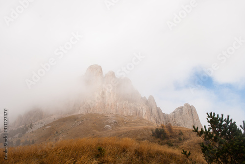 Bolshoy Tkhach cliff in fog photo