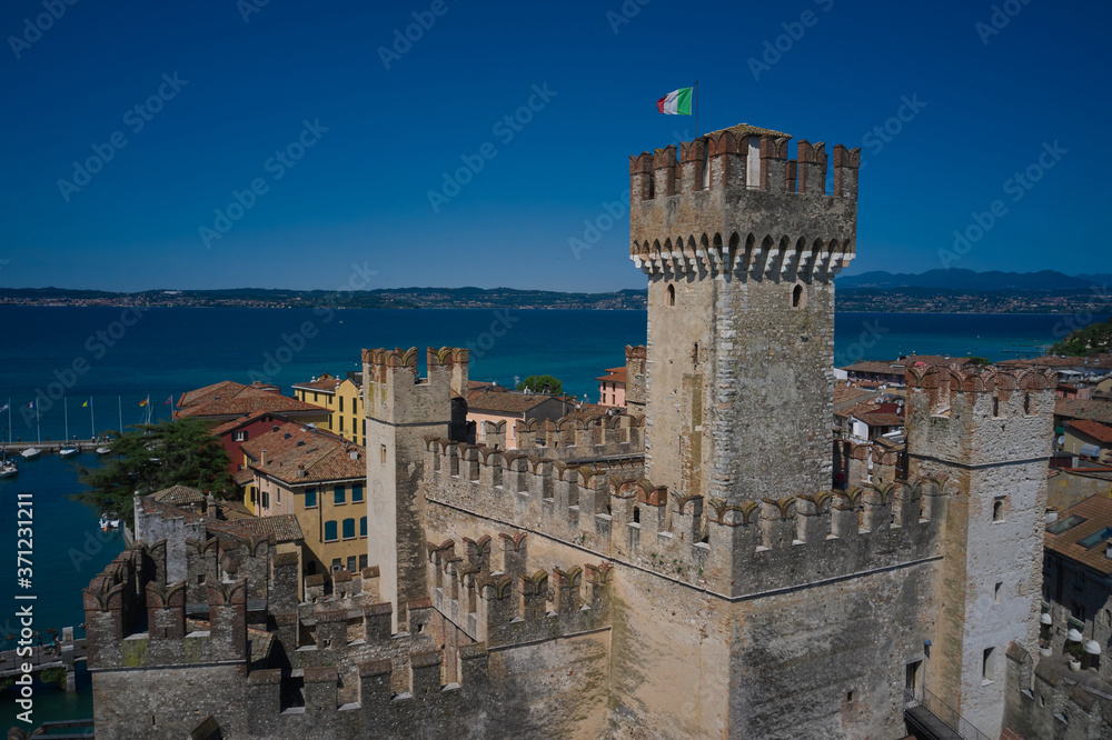 Sirmione, Lake Garda, Italy. Aerial view of Sirmione Castle. Close view of the Italian flag on the main tower.