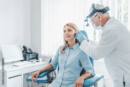 Middle aged female patient visiting doctor otolaryngologist