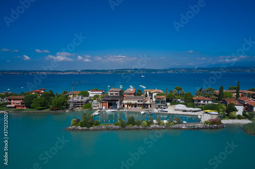 View by Drone. Aerial view on Sirmione sul Garda. Italy, Lombardy. Parking for boats in Sirmione
