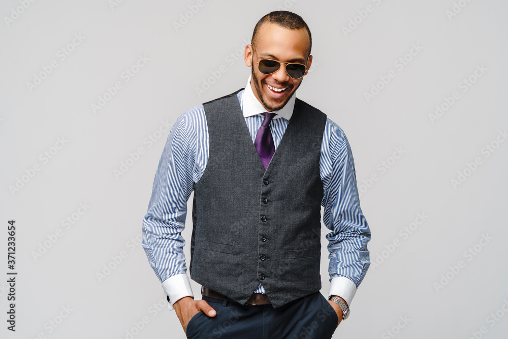 Fototapeta premium Studio shot of young African-American businessmanman over grey background