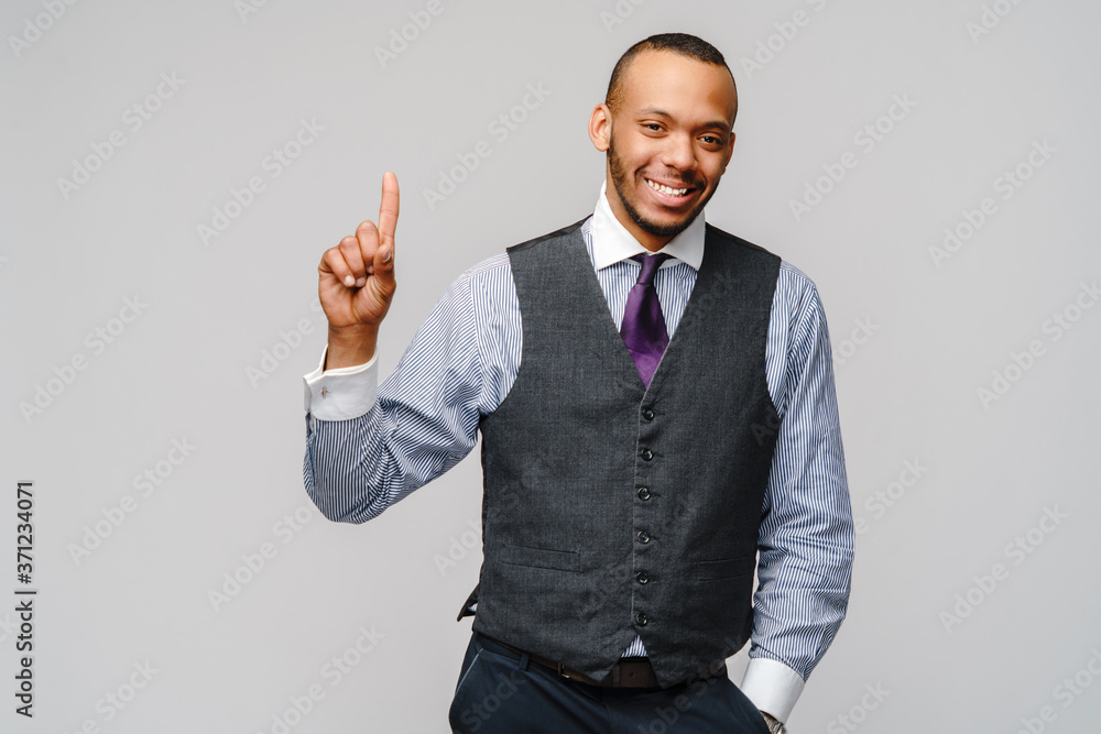 African-American businessmanman showing ONE by finger over grey background African-American businessmanman showing ONE by finger over grey background