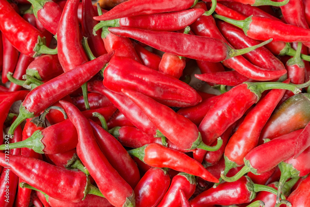 lots of ripe red peppers as a natural background for vegetables