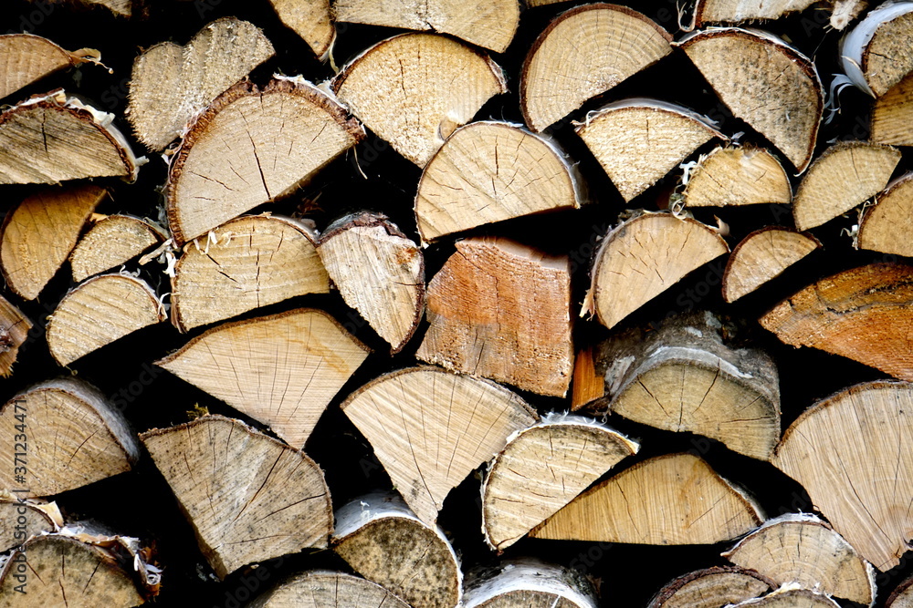 Natural wooden background,closeup of chopped firewood, Stack of dry chopped wooden logs Natural wooden background,closeup of chopped firewood, Stack of dry chopped wooden logs