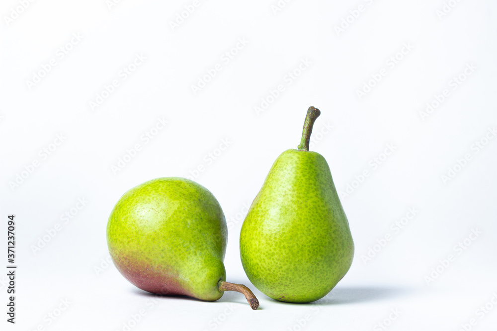 Green pear on a white background. Two pears next to each other. Summer harvest. healthy fruits Green pear on a white background. Two pears next to each other. Summer harvest. healthy fruits