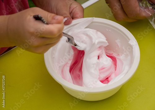 bowl with a colorful slime, making a slime at a birthday party, children's games - making a slime