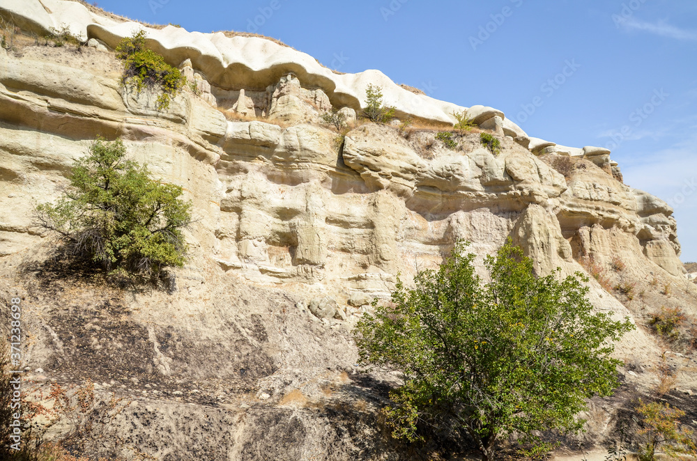 Majestic view at bizarre sandstone slopes and stone rock formations in valley of Cappadocia, Turkey