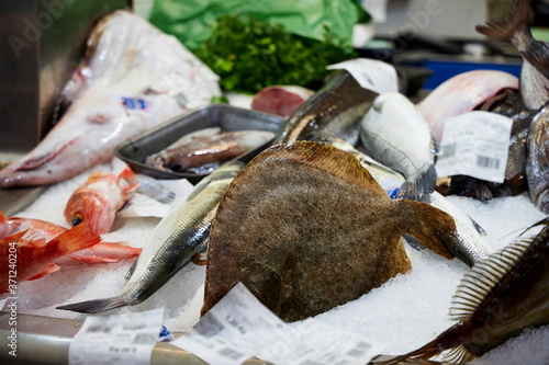 Bandeja con rodaballo y otros pescados en un mercado español photo