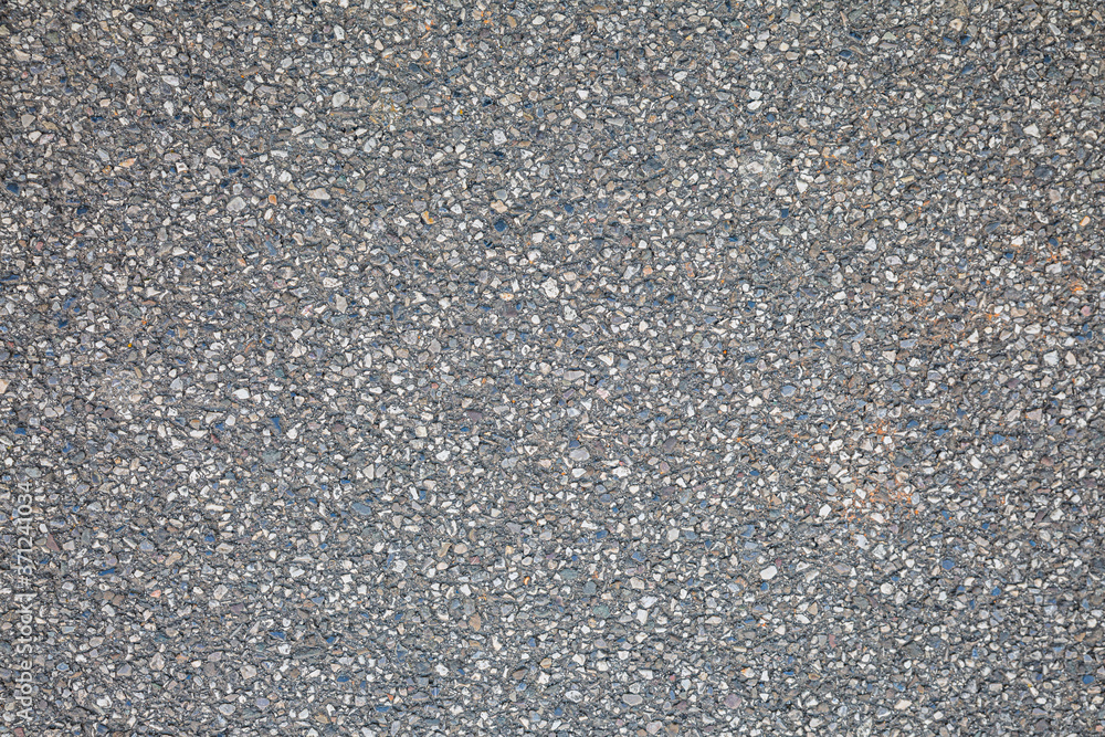 Stony surface of asphalt. Tarmac grey grainy road. Texture Background. Top view Stony surface of asphalt. Tarmac grey grainy road. Texture Background. Top view