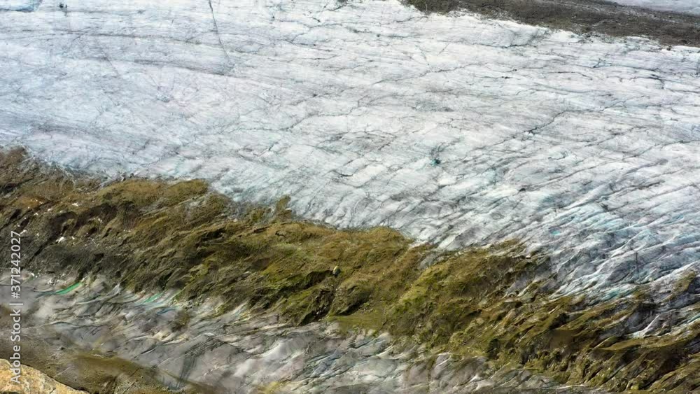 Close up of Aletsch Glacier in Switzerland the biggest Glacier in the Alps under the blue sky - aerial view with a drone 4K