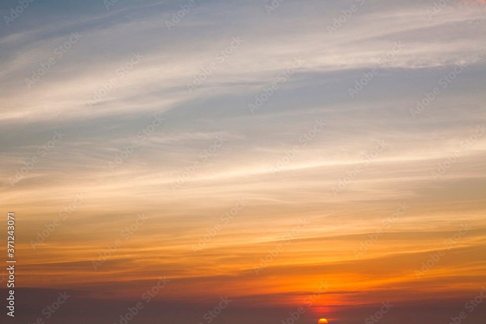 Colorful beautiful sunset with the orange cloud background