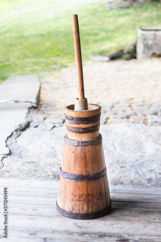 Photography Butter churn - old traditional wooden plunger-type butter churn with staff