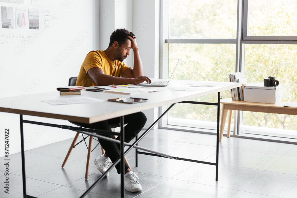 Tired man planning event in office Tired man planning event in office
