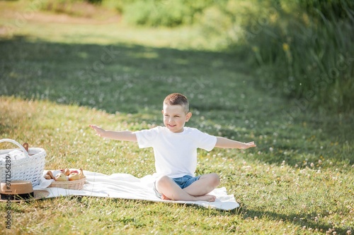 Young beautiful family having lunch by the lake. Summer picnic. photo