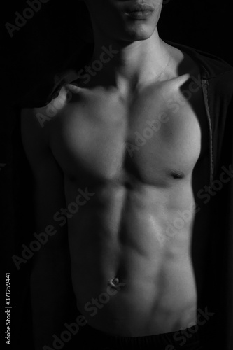 Medellín, Antioquia / Colombia. September 07, 2019. Muscular male torso on a black background 