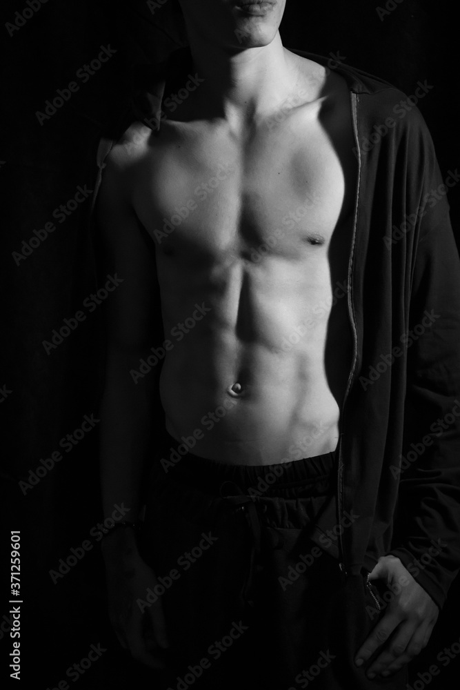 Naklejka premium Medellín, Antioquia / Colombia. September 07, 2019. Muscular male torso on a black background