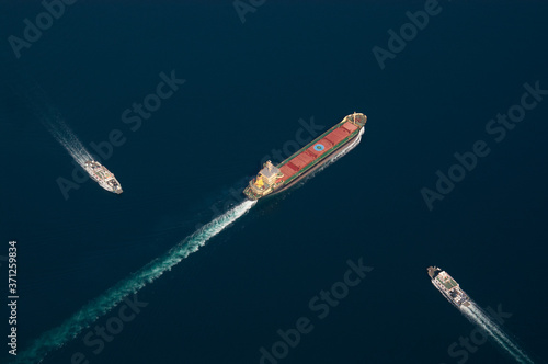 Graphic aerial shot of a freighter and two ferryboats