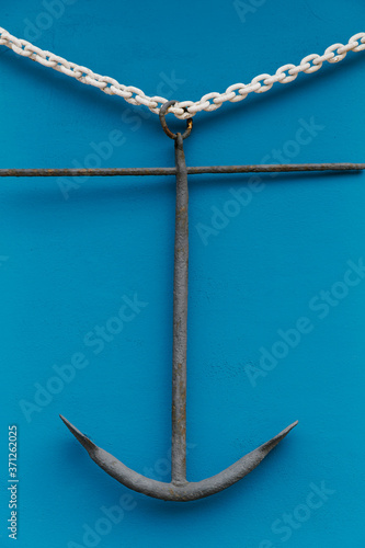 Anchor Hanging on Blue Wall in Coastal town photo