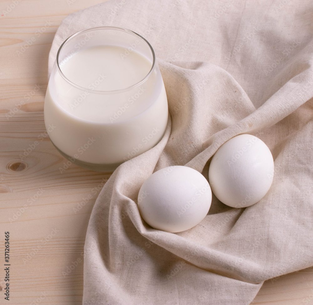 two white eggs and milk as calcium concept. minimalism style. two white eggs and milk as calcium concept. minimalism style.