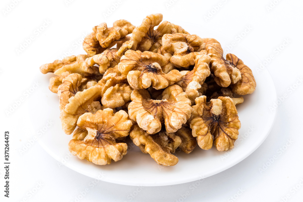 Close-up of delicious walnuts on a white dish Close-up of delicious walnuts on a white dish