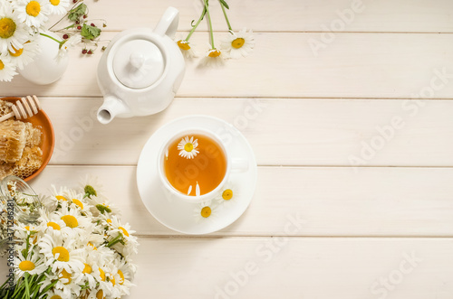 Chamomile and honey tea with copy space on white background