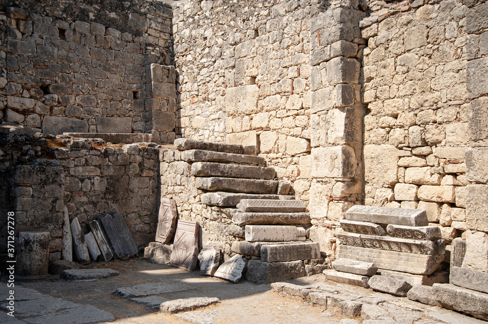 Stone wall with steps on the ruins of a temple or castle