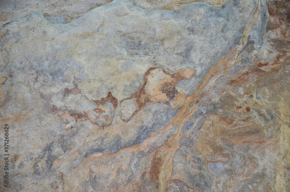 Details of sand stone texture, closeup shot of rock surface with vignette at cover and bright spot at centre, idea for background or backdrop. Details of sand stone texture, closeup shot of rock surface with vignette at cover and bright spot at centre, idea for background or backdrop.