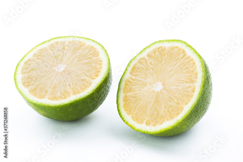 slice of fresh lemon that was cut in half isolated on white background