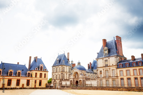 Historic buildings in inner yard of French king royal Fontainebleau palace, France