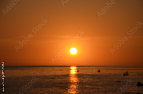 Beautiful sunset above the sea reflection of the setting sun in the water. © Dilya