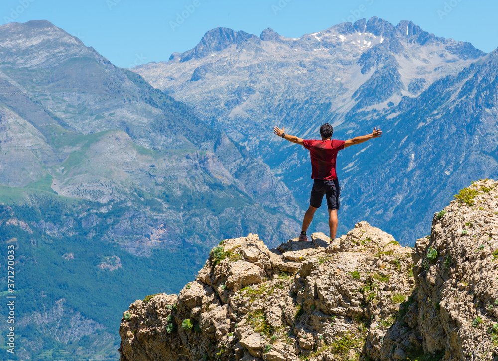 Male hiker standing on top of mountain. Active lifestyle concept.