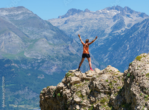 Female hiker standing on top of mountain. Active lifestyle concept.