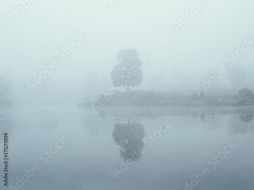 Mystical morning landscape with fog over the lake. Soft focus