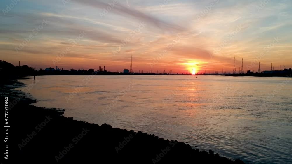 Right panning shot of golden hour sunset cloudscape at harbor. Aerial view shot by drone Right panning shot of golden hour sunset cloudscape at harbor. Aerial view shot by drone