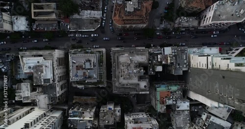 2020 Beirut port explosion: aerial aftermath directly above destruction, devastation and destroyed buildings by ammonium nitrate blast in downtown industrial warehouse, overhead drone descend photo