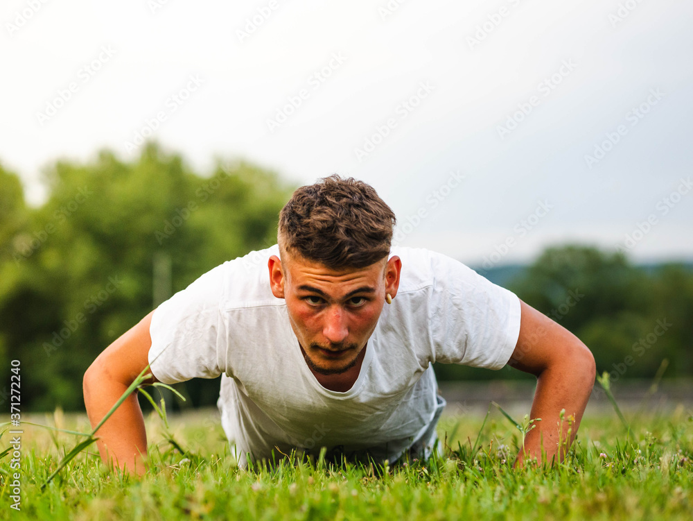 Young Caucasian man during an outdoors workout Young Caucasian man during an outdoors workout