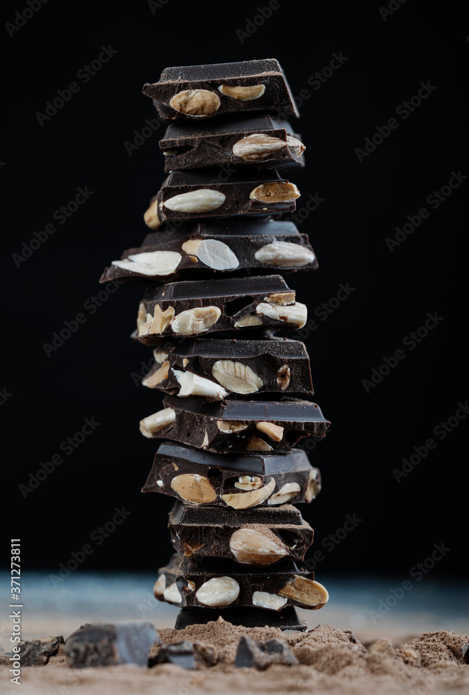 chocolate tower with almonds on black background