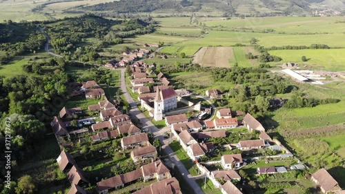 Aerial footage of an old church castle fortress in Viscri Saschiz Sighisoara Romania Transylvania Unesco photo
