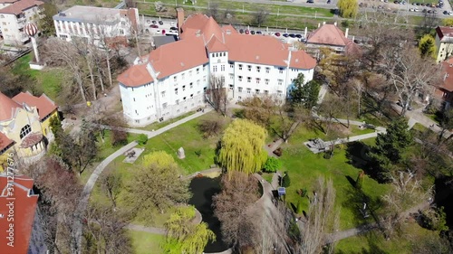 Aerial Drone Shot paning over above Universitatea Oradea Campus with students photo