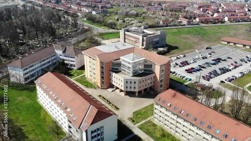 Aerial Drone Shot paning over above Universitatea Oradea Campus library with students photo